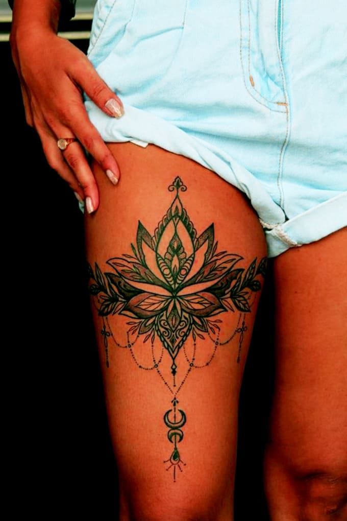 Mandala magic meets lotus elegance in this stunning thigh piece that cascades down the leg like botanical jewelry ✨ The intricate green linework and delicate dotwork chains create a mesmerizing ornamental design that follows the natural curve of the body. Perfect placement that transforms the thigh into a canvas for this symmetrical masterpiece of sacred geometry.