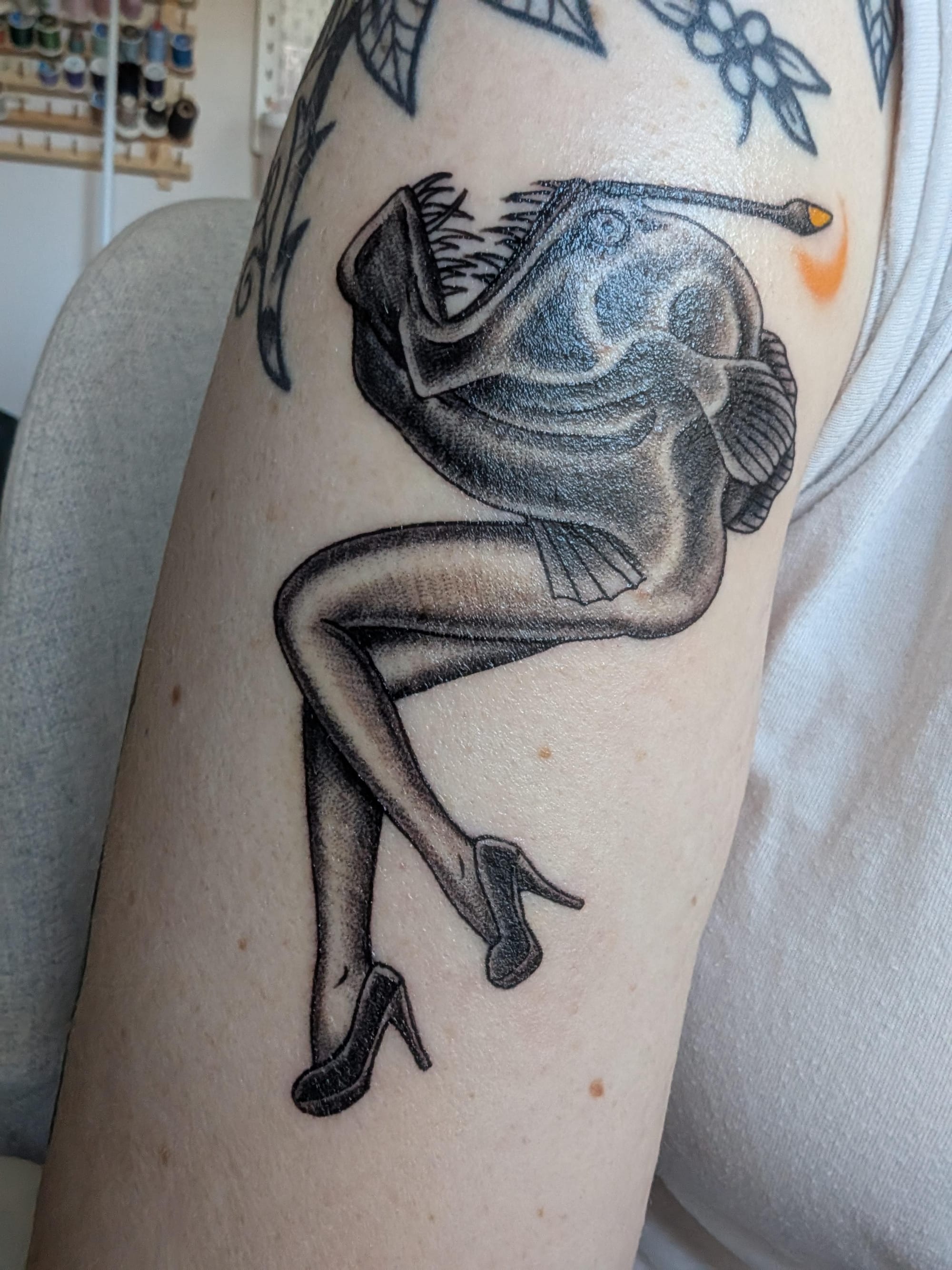 Masterful linework brings this serpentine beauty to life, featuring an eel or sea snake adorned with flowing fins that seem to ripple with underwater grace. The artist's skilled shading technique creates incredible depth and movement, making the creature appear to glide effortlessly around the arm's natural contours. 🌊 A stunning example of how marine life tattoos can capture both the mystery and elegance of the deep.