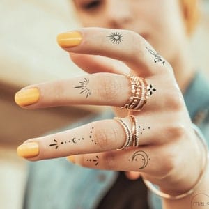 Delicate celestial symbols dance across fingertips in this enchanting hand tattoo collection, featuring suns, moons, and mystical dots that create a bohemian constellation on skin. The fine line work paired with minimalist rings transforms everyday gestures into magical moments ✨ Perfect for those who want to carry a piece of the universe wherever they go.