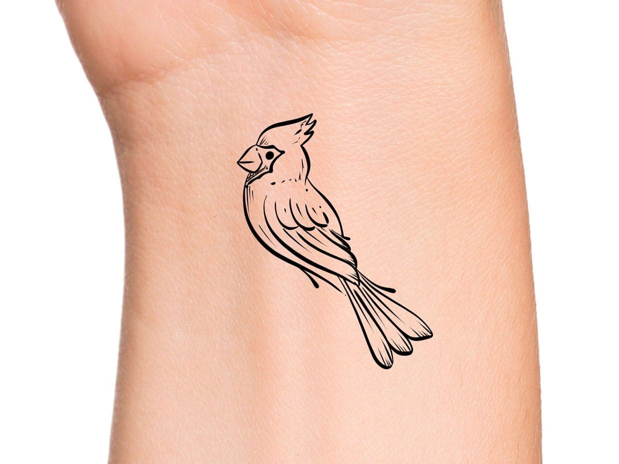 Delicate line work brings this cardinal to life with stunning simplicity on the forearm. The minimalist black outline style perfectly captures the bird's distinctive crest and elegant posture, creating a timeless piece that celebrates both nature's beauty and artistic restraint 🕊️