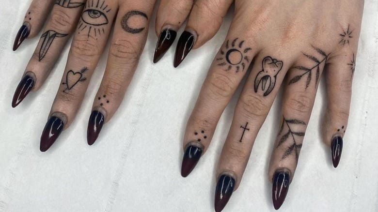 Delicate mystical symbols dance across each finger like a personal grimoire written in ink ✨ From all-seeing eyes to celestial suns and sacred crosses, this collection of fine-line finger tattoos creates an enchanting tapestry of spiritual iconography. The minimalist black linework paired with those dramatic dark burgundy nails creates the perfect balance between witchy elegance and modern edge.