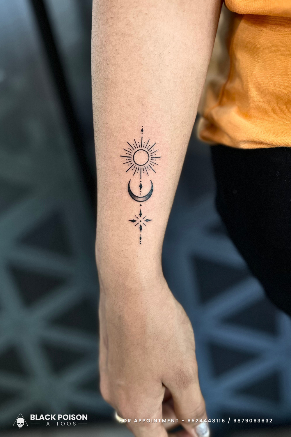 Celestial alignment flows down the forearm in this delicate blackwork piece, featuring a radiant sun, crescent moon, and compass star connected by subtle dotted lines. The minimalist linework creates a stunning vertical composition that captures the eternal dance between day and night ✨ Perfect placement for those who find guidance in the cosmos above.