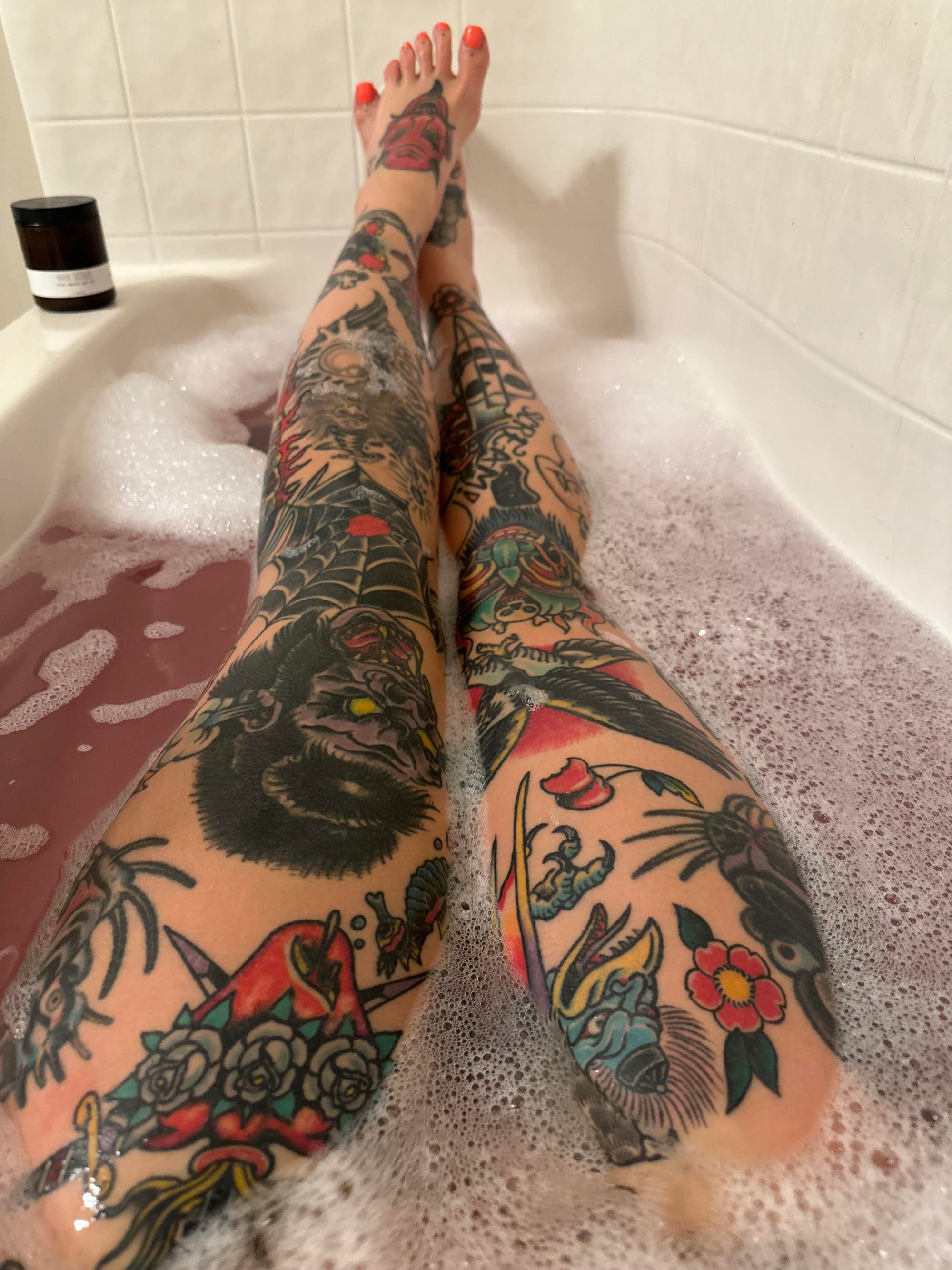 From ankle to thigh, these legs showcase a masterful collision of traditional Japanese artistry and bold American tattooing 🐉 The intricate serpents, blooming florals, and mythical creatures create an almost textile-like pattern that transforms skin into a living canvas. Notice how the artist seamlessly blended each element to flow with the natural curves of the legs, creating a cohesive masterpiece that demands appreciation from every angle.