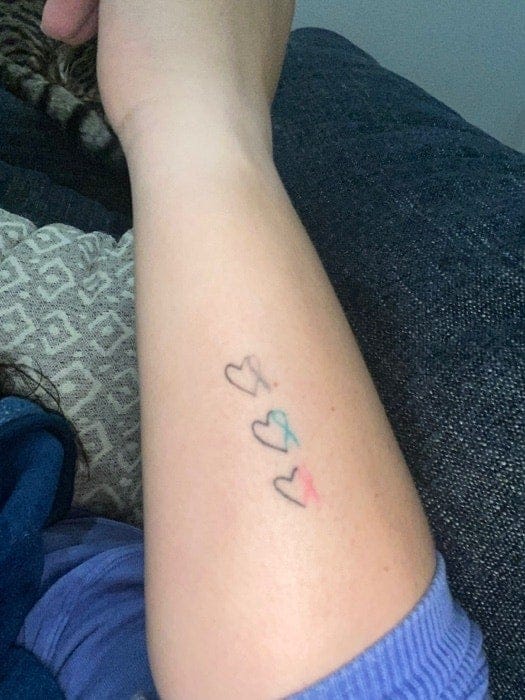 Three delicate hearts cascade down this forearm like gentle raindrops, each one filled with a different pastel hue that creates the sweetest minimalist statement. The simple line work and soft color palette transforms a classic symbol into something wonderfully modern and understated ✨ Perfect placement for catching glimpses of color throughout the day!