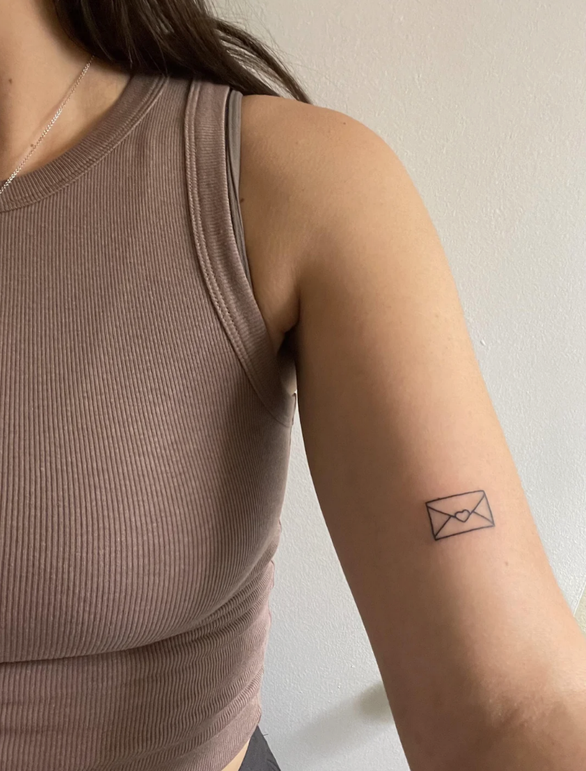 Minimalist line work meets meaningful symbolism in this delicate envelope tattoo positioned perfectly on the inner arm. The clean, geometric design captures that nostalgic feeling of handwritten letters and meaningful connections, while the subtle placement makes it a sweet personal reminder that's easy to conceal or show off ✉️