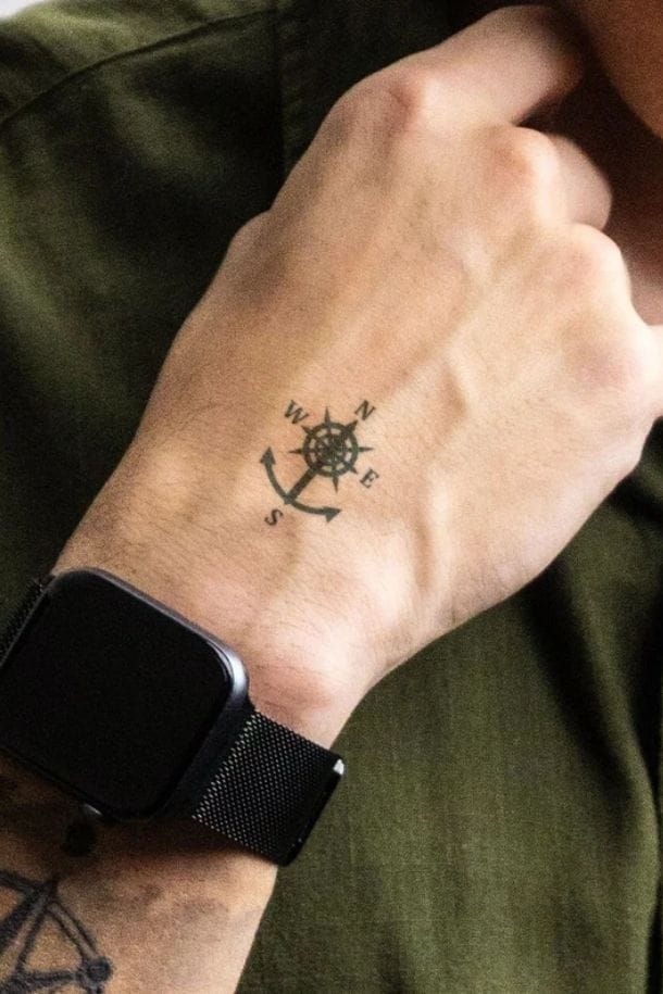 Delicate nautical symbolism meets modern minimalism in this perfectly sized hand tattoo featuring a compass rose paired with an anchor ⚓ The clean linework and strategic placement on the hand creates an everyday reminder of staying grounded while navigating life's journey. A timeless maritime duo that speaks to wanderers with steady hearts.