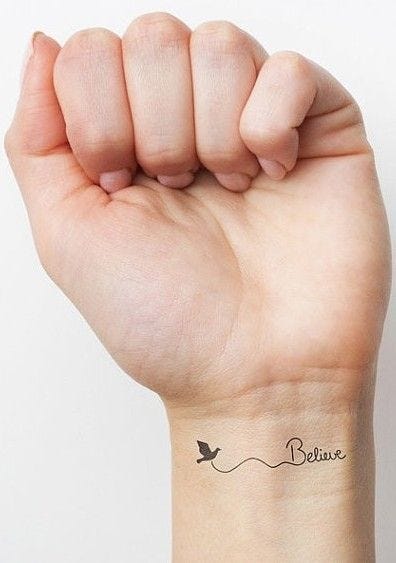 Delicate script flows across the wrist like a gentle whisper, paired with a tiny bird that seems ready to take flight at any moment. The minimalist design captures the essence of hope and personal mantras in the most elegant way possible ✨ Perfect for those who believe in the power of simple reminders that dreams really can soar.