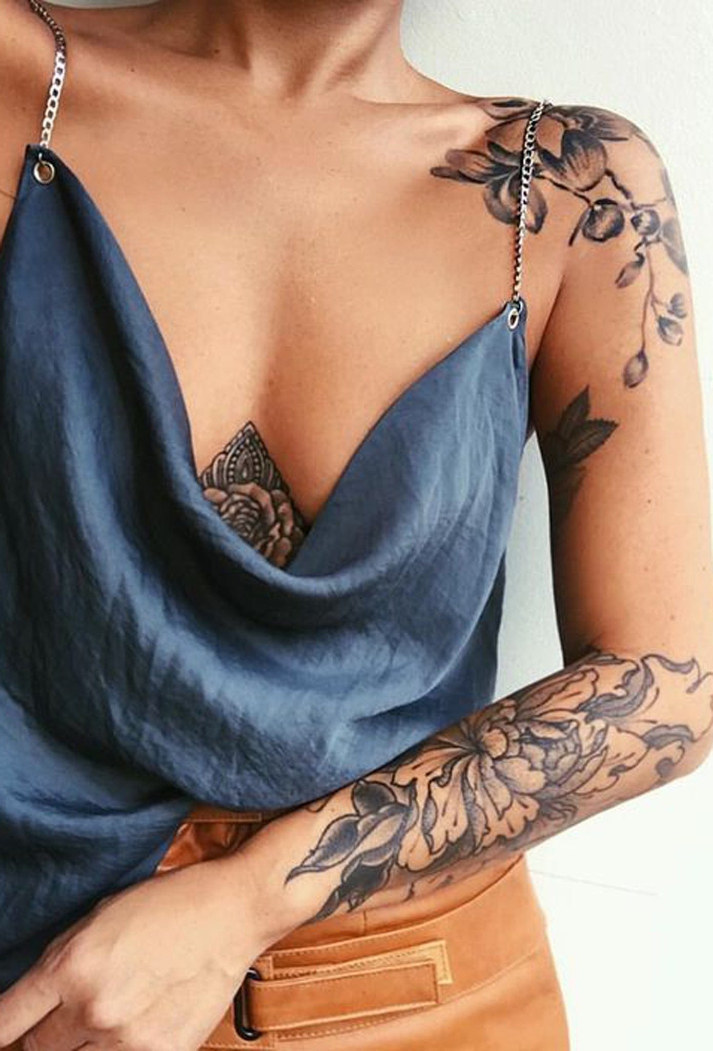 Delicate botanical artistry flows seamlessly from shoulder to forearm in this stunning floral sleeve, creating an organic garden that seems to bloom right from the skin. The soft, muted tones and intricate petal details showcase incredible tattooing technique, while the placement perfectly complements the feminine silhouette 🌸 A true masterpiece that transforms the arm into living art.