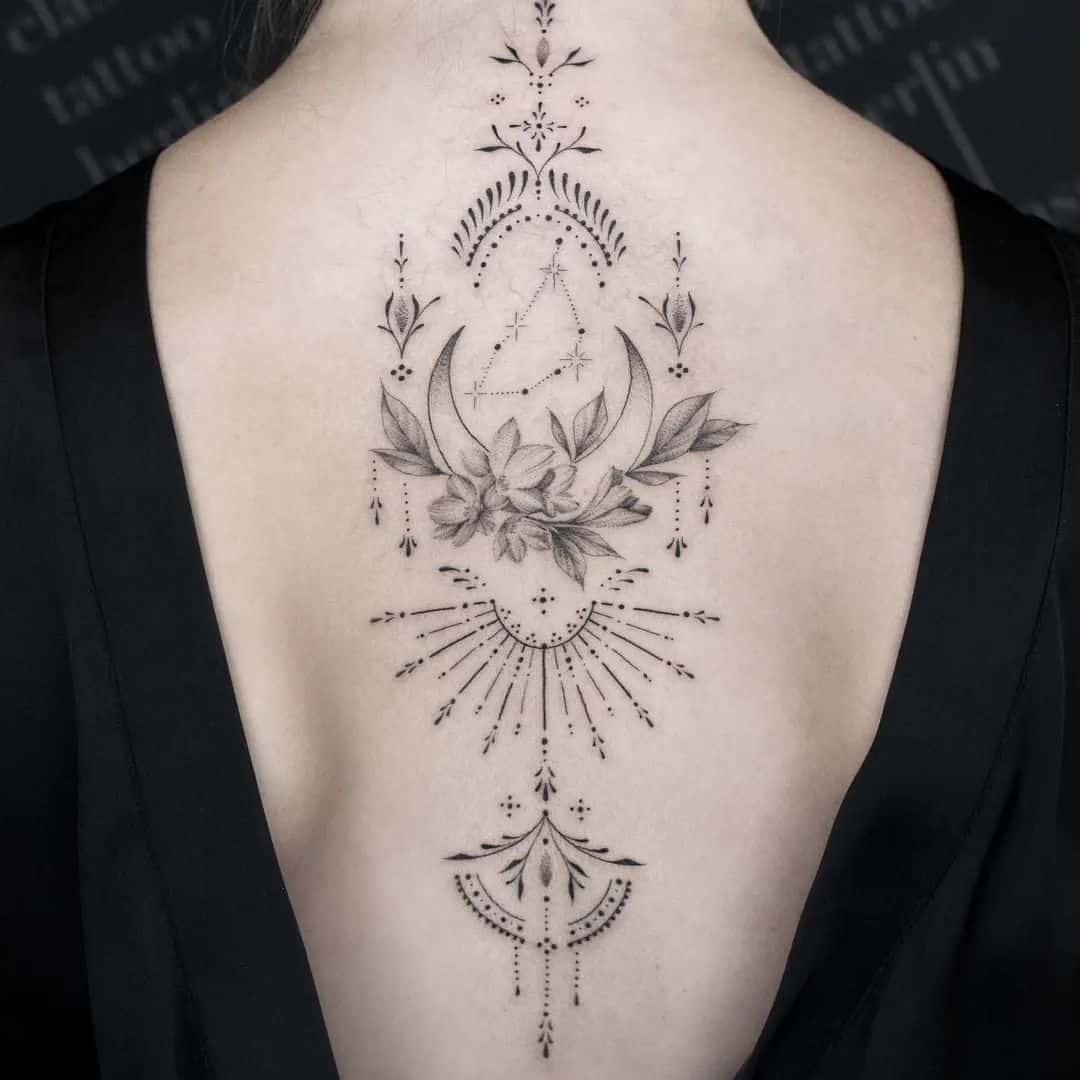 Celestial magic flows down this spine in perfect symmetry ✨ The crescent moon cradles delicate botanicals while geometric patterns and dotwork create an enchanting mandala-inspired piece that follows the natural curve of the back. Fine line artistry meets spiritual symbolism in this breathtaking display of feminine mystique.