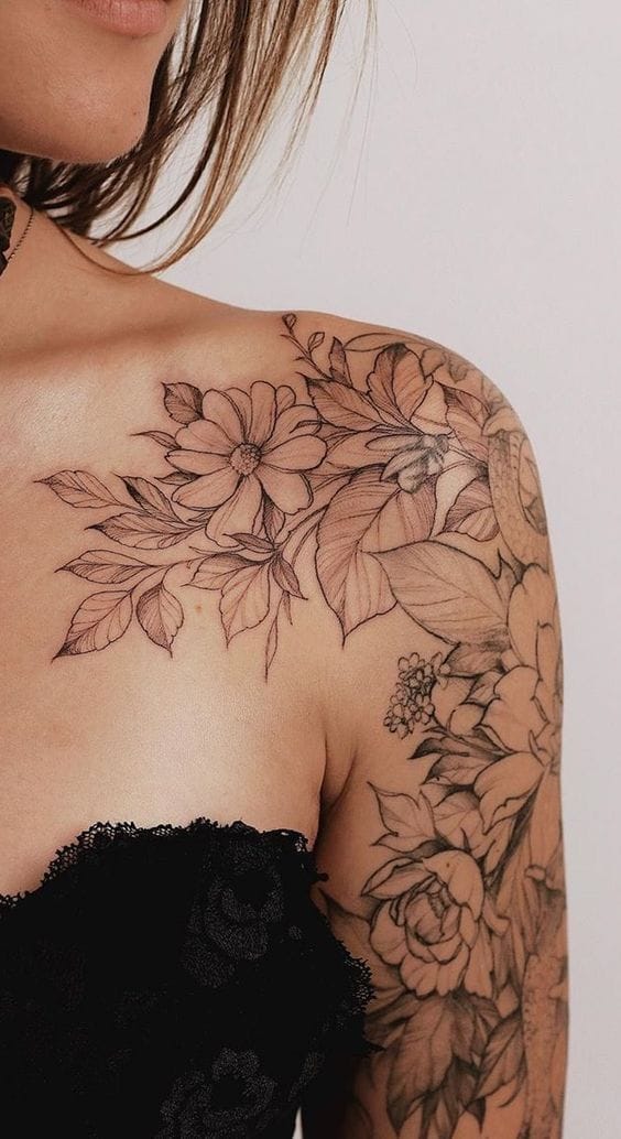 Cascading across the shoulder and down the arm like nature's own masterpiece, this intricate floral sleeve features delicately outlined blooms and foliage that seem to dance with every movement. The fine line work and botanical details create an ethereal garden that perfectly complements the feminine silhouette, making this piece both romantic and boldly artistic 🌸