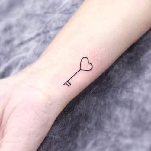 Sometimes the most powerful statements are whispered rather than shouted, like this delicate heart-arrow tattoo that graces the inner forearm with understated elegance. The minimalist line work transforms a classic symbol of love into something refreshingly modern, proving that romance doesn't need elaborate flourishes to pierce straight through to the soul. 💕