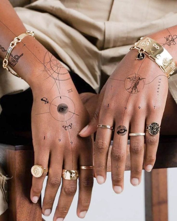 Celestial cartography meets skin art in this mesmerizing hand tattoo duo that transforms palms into mystical navigation charts ✨ Intricate line work creates geometric patterns, planetary symbols, and cosmic imagery that flows seamlessly across fingers and palms, while gold jewelry adds an ethereal finishing touch to this otherworldly design.