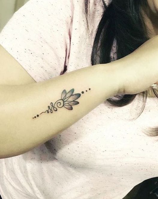 Delicate lotus petals dance along this inner forearm, creating an elegant botanical statement that feels both timeless and modern. The minimalist linework flows seamlessly with the arm's natural curve, while tiny dotwork details add just the right amount of texture without overwhelming the design's graceful simplicity. 🌸