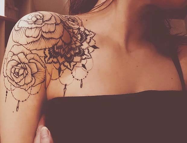 Delicate linework transforms this shoulder into a botanical masterpiece, where intricately detailed roses and mandala-inspired florals cascade across the skin like vintage lace. The ornate dotwork and geometric accents create stunning depth, proving that black ink artistry can be both bold and beautifully feminine ✨