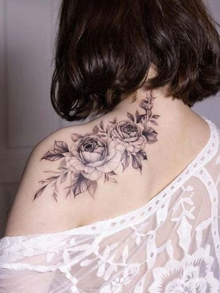 Cascading roses bloom across shoulder and back in this breathtaking black and grey masterpiece, creating an elegant garden that flows naturally with the body's curves. The delicate shading and botanical details paired with that romantic lace top make this placement absolutely divine 🌹 Perfect inspiration for anyone dreaming of feminine floral ink that's both bold and graceful.