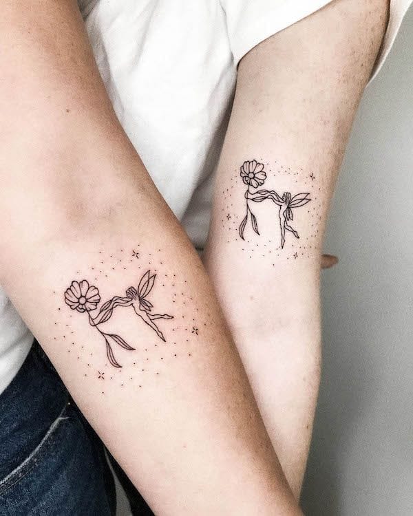 Delicate line work transforms these forearms into a whimsical garden where fairy-like figures dance among blooming flowers ✨ The matching placement creates perfect symmetry while tiny dots and stars add an enchanting celestial quality to these minimalist botanical beauties.
