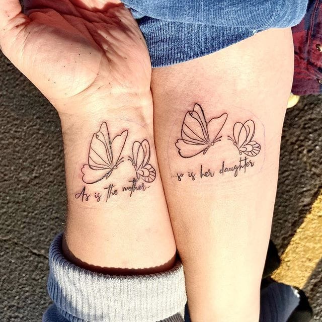 Delicate line work transforms matching butterflies into a heartfelt tribute between mother and daughter, with 