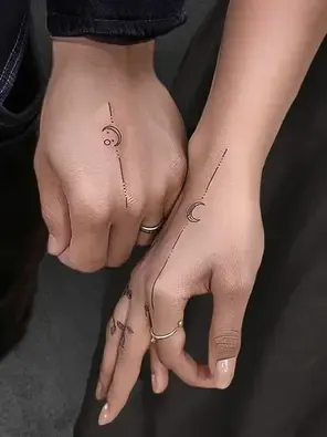Delicate linework transforms these hands into a celestial canvas, where minimalist moons and geometric elements dance across skin like a modern astrology chart. The precise placement along fingers and knuckles creates an ethereal hand jewelry effect that's both mystical and sophisticated ✨