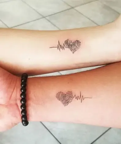 Heartbeats transform into fingerprint hearts in this deeply personal matching tattoo set that speaks to souls intertwined. The delicate line work creates an intimate visual story - one person's pulse literally becoming the other's heartprint, symbolizing how love leaves its unique mark on our very life rhythm. Perfect for couples who want their bond etched in the most romantic way possible ❤️