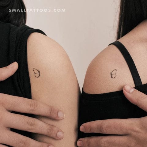 Minimalist magic strikes twice with these perfectly matched acorn silhouettes adorning each shoulder blade. The delicate line work creates an understated botanical moment that's both whimsical and sophisticated—proof that the tiniest symbols can carry the deepest meaning 🌰