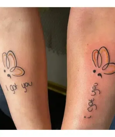 Delicate butterfly outlines flutter across two arms, connected by matching 