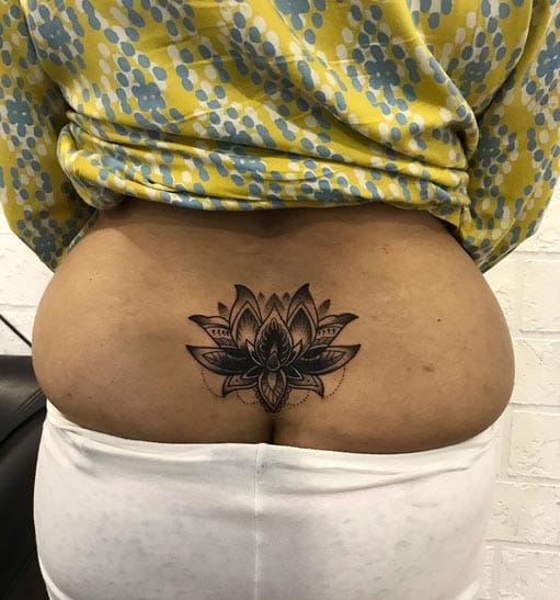 Delicate mandala petals unfold across the lower back in this stunning geometric lotus design, creating a mesmerizing focal point that celebrates both spiritual symbolism and artistic precision. The intricate linework and symmetrical patterns transform this sacred flower into a masterpiece of body art that flows beautifully with the body's natural curves 🪷