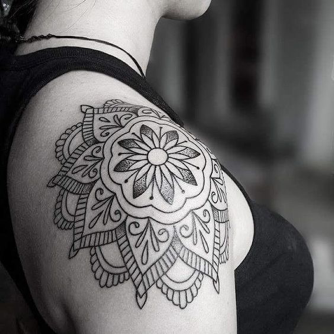 Graceful mandala petals cascade down this shoulder like a blooming lotus frozen in time, each intricate line flowing seamlessly into decorative flourishes that dance across the skin. The delicate balance between the central floral medallion and its ornate surrounding details creates a mesmerizing piece that celebrates both geometric precision and organic beauty 🌸