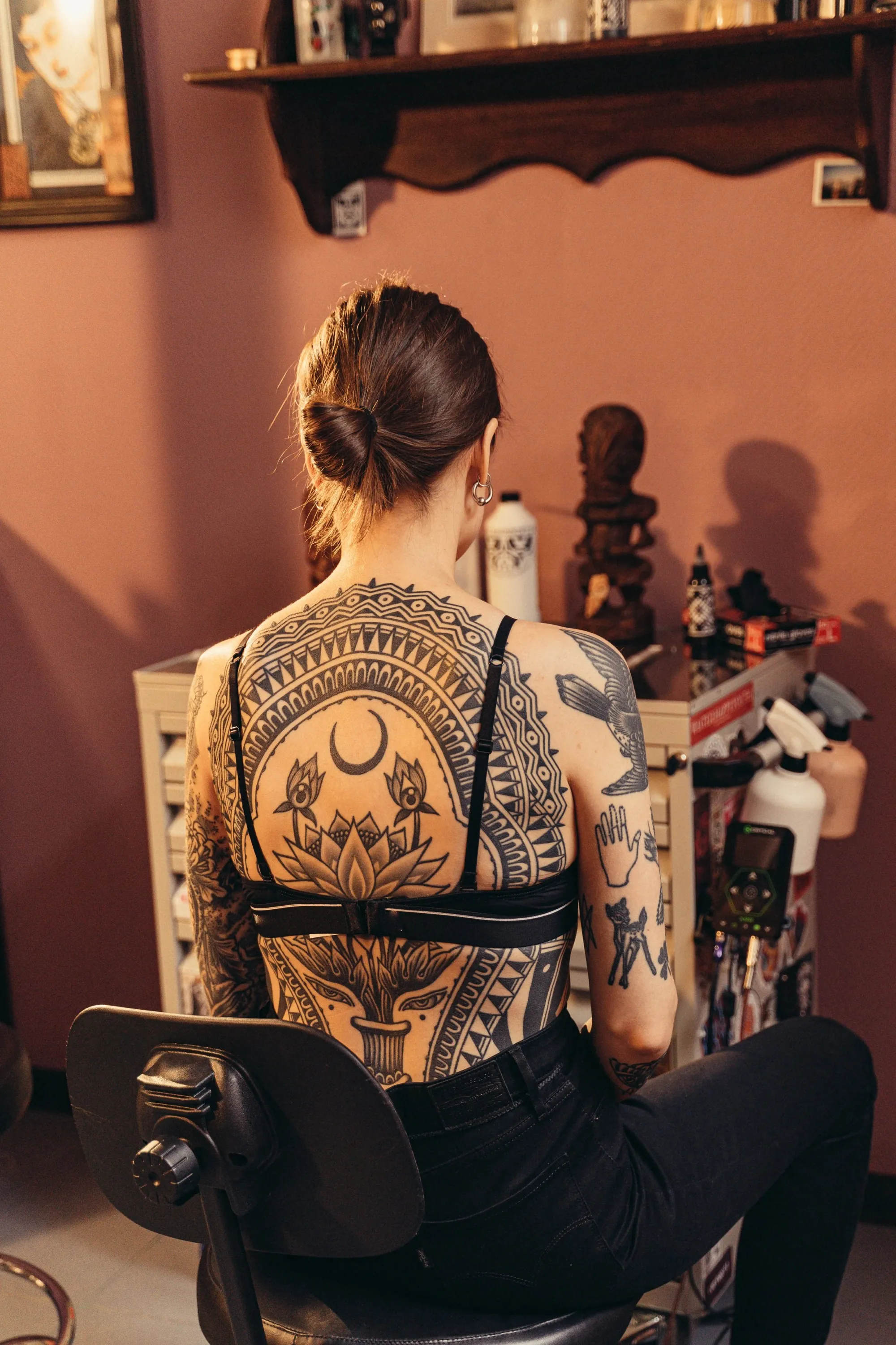 Sacred geometry meets spiritual symbolism in this breathtaking full-back masterpiece, where intricate mandala patterns frame a lotus bloom beneath a crescent moon 🌙 The bold tribal-inspired linework creates stunning visual depth, transforming the entire back into a canvas of ancient wisdom and artistic mastery.