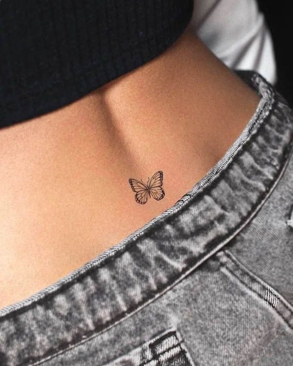 Delicate line work transforms into pure elegance with this minimalist butterfly perched perfectly on the hip bone. The fine black outlines create an almost ethereal quality, while the strategic placement along the natural curve of the body makes it feel like the butterfly just landed there moments ago 🦋