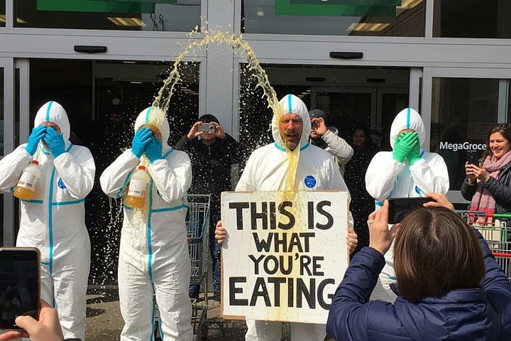 Organic food advocates douse themselves in fake pesticides to highlight risks